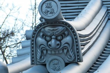 A gargoyle on the roof of the entrance gate