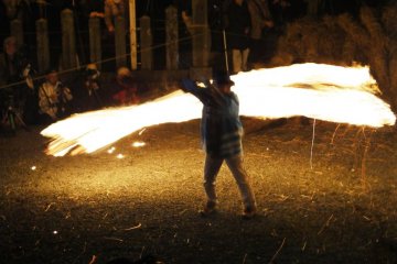 A volunteer swings a torch