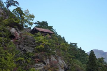 Photo from Yamadera Temple over the side of the mountain with a temple building on the edge of a cliff