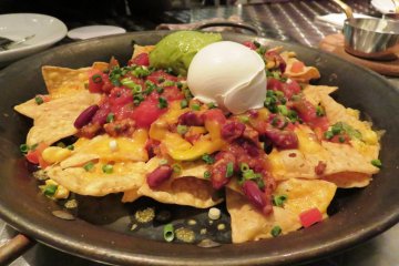 Crowd pleasing nachos with the freshest cream and avocado