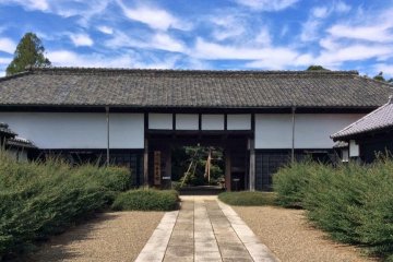 The imposing gate hints at the grand house beyond