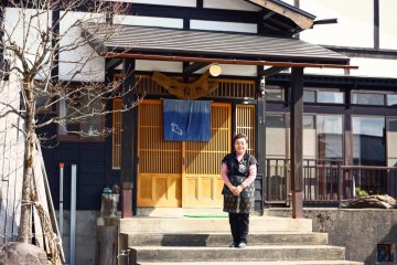 <p>Eiko-san stands outside the restaurant, which is built in the traditional Kaneyama style.</p>