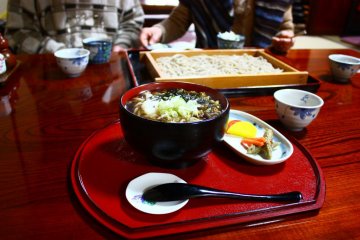 Tororo nameko soba in the foreground, and a bamboo tray of ita soba behind.