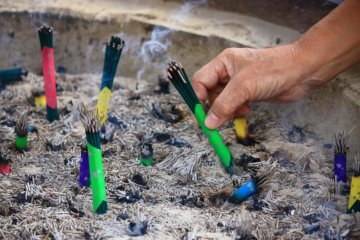As you enter the temple, take a moment to light some incense.