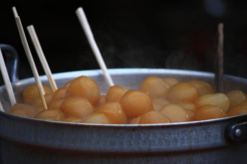 If you're feeling hungry, you can buy a stick of konnyaku balls, served with a dab of hot mustard.