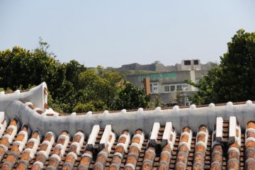 Nakagusuku Castle towers in the distance beyond the Nakamura House.