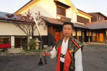 Our swordsman explains the history of his sword after a demonstration of its sharp cutting ability