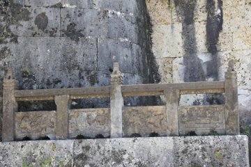 <p>Shisa dogs line a stone fence along the entrance to the western room where family members other than kings and queens were entombed</p>