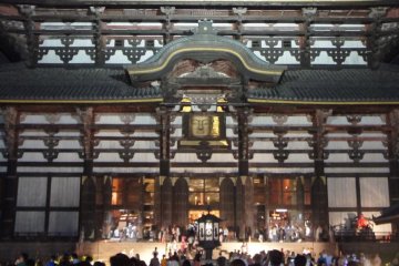 The buddha statue can be seen through the square opening in this photograph: the night-time view is so calm and very different from the the daytime view