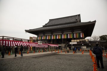Barricades are set up around the raised platform outside Dai-Hondo, the main hall, before the bean throwing event. Crowds gather almost an hour before the ceremony to secure prime spots for catching the beans.