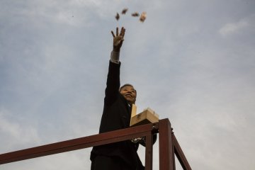 A celebrity throwing bean packets to the crowd. There were about four waves of celebrities who came out during the 40-minute event.
