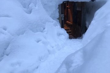 An entrance buried in snow