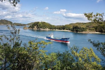 Ships chug by in the channel just beyond the campsite