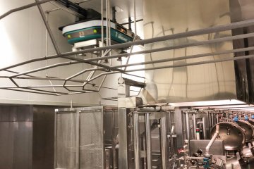 Cute little automated robots transporting the red beans