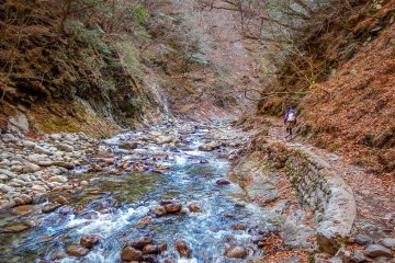  As you make your way to the large falls, known as Nanatsugama Goden Waterfall, the valley widens out with the trail now traversing along a narrow path