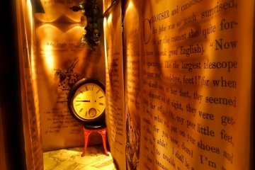 A labyrinth entrance full of storybook pages leading up to the clock. "I'm late! I'm late! For a very important date!"