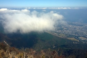 On one side lies the city of Beppu and the sea