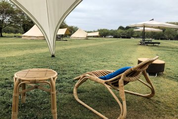 Bask in the natural air on comfortable chairs outside your tent