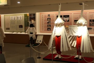 A costume of a Heron dance in the foreground and a Tsuwano Dance in the background