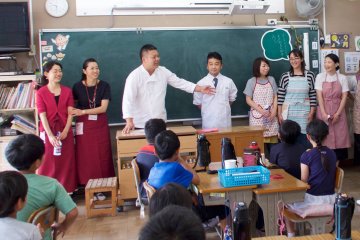 Chef Nobu Watanabe engages students in lively discussion as PTA members look on