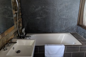 The bathroom also has the trendy, warehouse apartment feel.