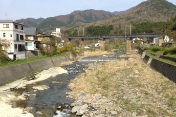 For most visitors your visit begins from the train station a five minute walk away. Cross this beautiful river and you head towards the mountains opposite the train station.