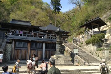 After almost 30 minutes of huffing up the mountain you have reached the top. A Buddhist statue can be viewed in the temple from the outside.