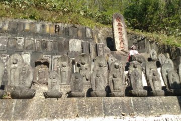 Dozens of Buddhas eagerly await visitors along a side path next to the top temple.