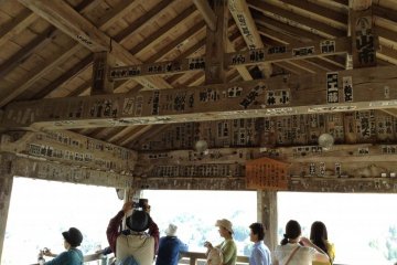 Inside the viewing platform you see what look like stickers. These are old postings from villagers that made the long trek from their villages before modern transportation systems.