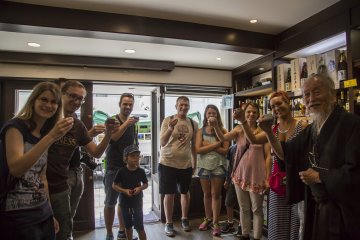 Tour members toast with Okada at a liquor store that's along the route
