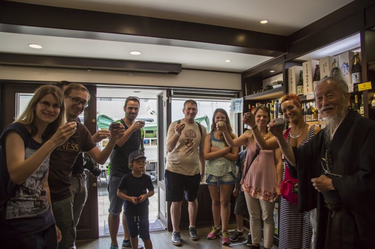 Tour members toast with Okada at a liquor store that's along the route