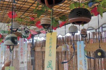 The hanging papers catch the wind and make the clapper strike the bell