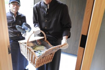Staff bring dinner and breakfast ingredients with a smile.
