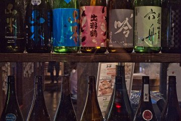 Empty old bottles on display in a restaurant