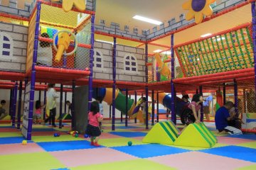<p>There is one toddler play area and three larger play areas like this one that each have an open center court surrounded by various play stations and topped by a second level of catwalks full of surprises</p>