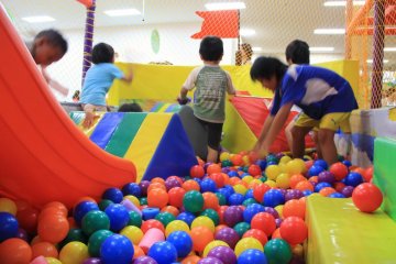 <p>Kids love to mix it up off of a slide into a ball pit surrounded by foam barriers and netting</p>