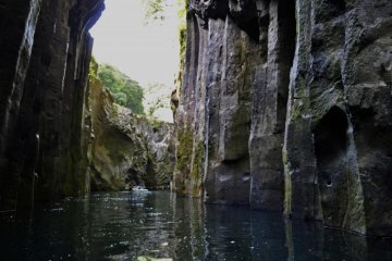 High volcanic basalt columns line the gorge