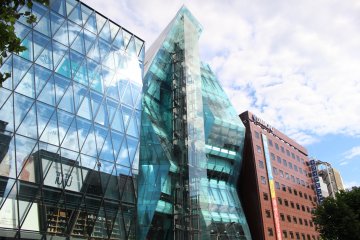 WeWork Iceberg: an asymmetric glass façade with external elevator shaft