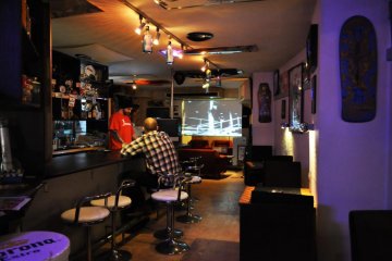 The owner Julien behind the bar