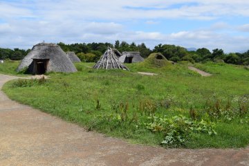 The structures with thatched roofs are particularly intriguing