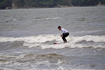 Surfers making do with the small waves