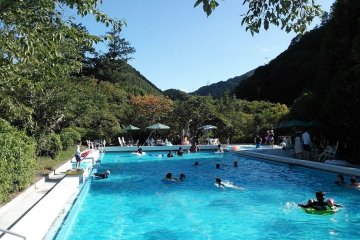 Outdoor pool surrounded by hills.