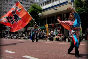 The dancers vary in age, style, and costume
