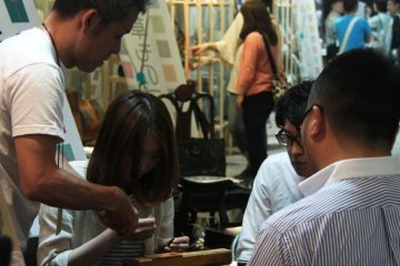 A leather-craft workshop where you could choose to do a handmade key ring or a pouch.