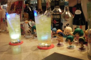 Drinks glow as figures look on