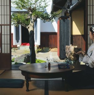 Sipping tea by an open shoji door