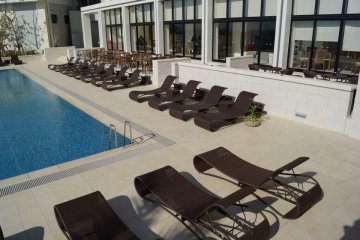 Beautiful beach chairs set along the outside of the hotel's outdoor pool.