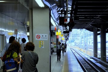 Travelers await the next train