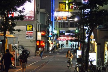 The city comes alive as the sun sets and lights come into effect.