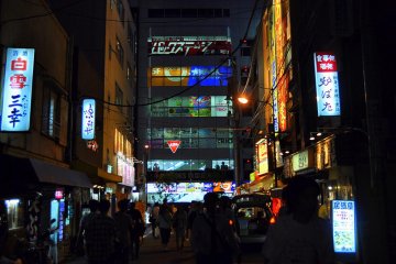 Akihabara side street at night, facing a multi-level store